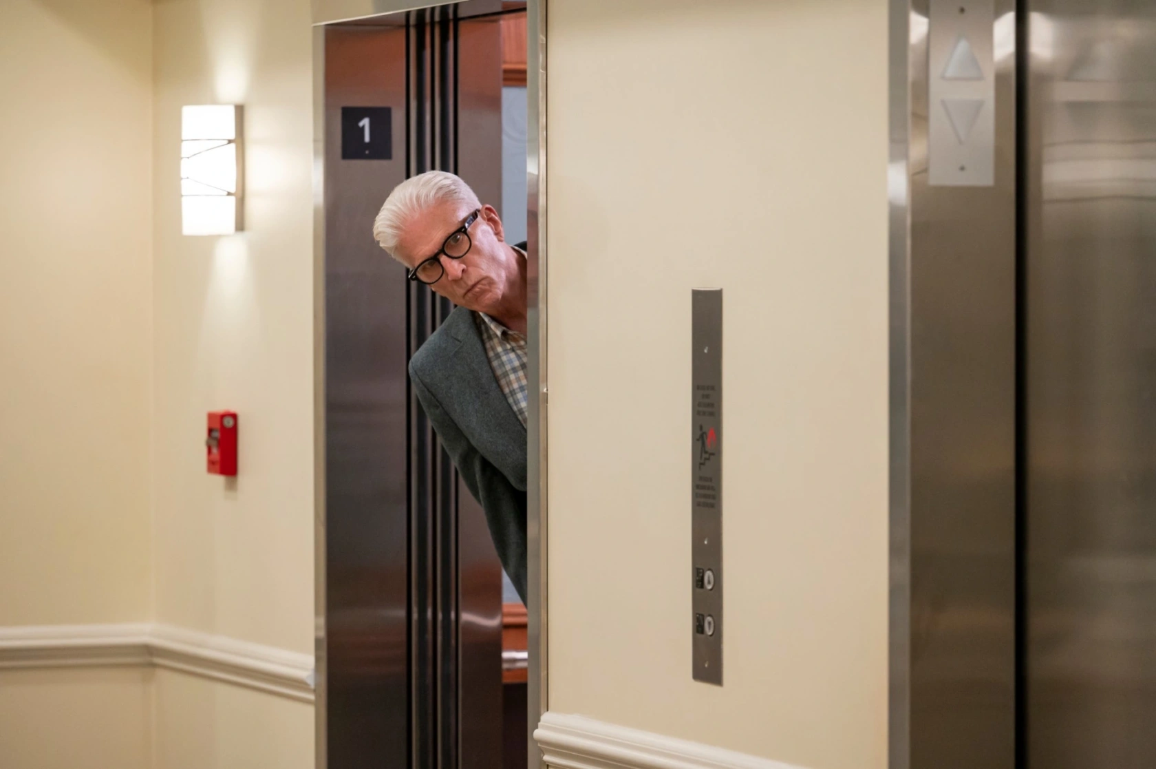 Ted Danson as Charles, peering out of an elevator in 'A Man on the Inside'