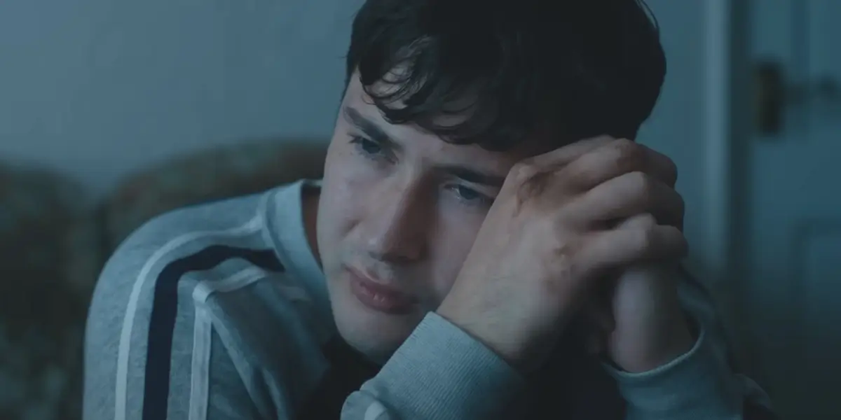 A worried Ronan Day-Lewis rests his face against his hands in Anemone.