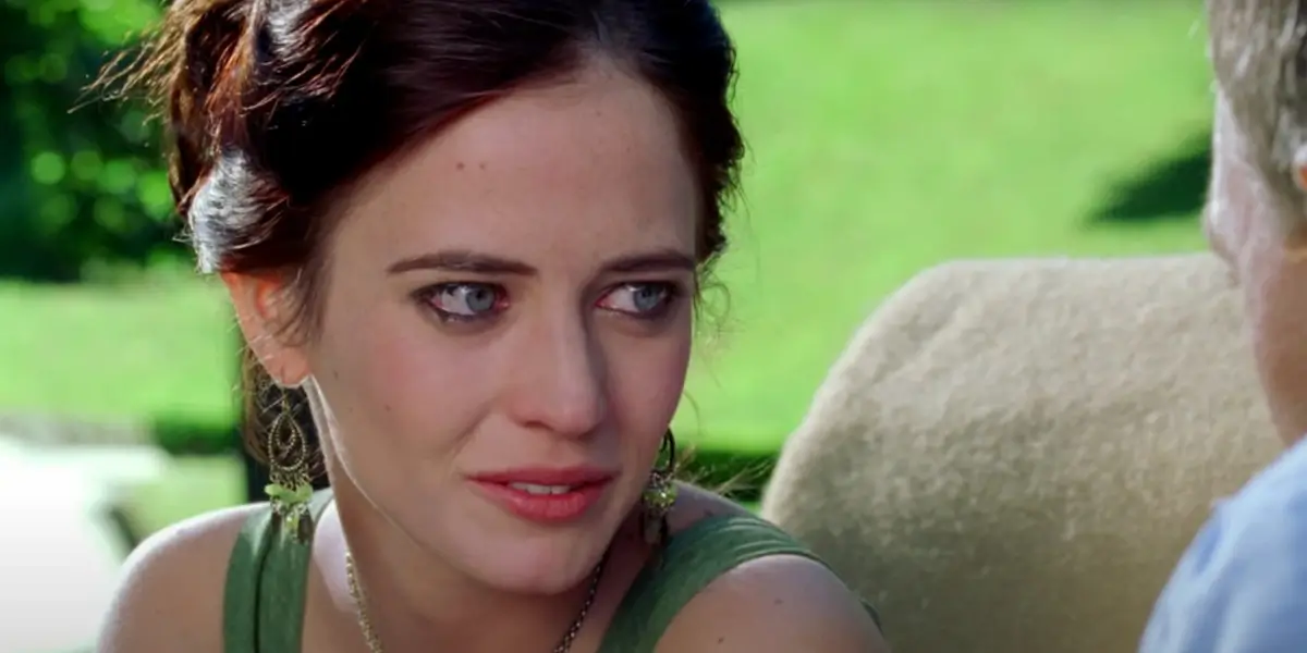 Eva-Green smiles-bittersweetly while-sitting in front of Daniel Craig in Casino Royale.