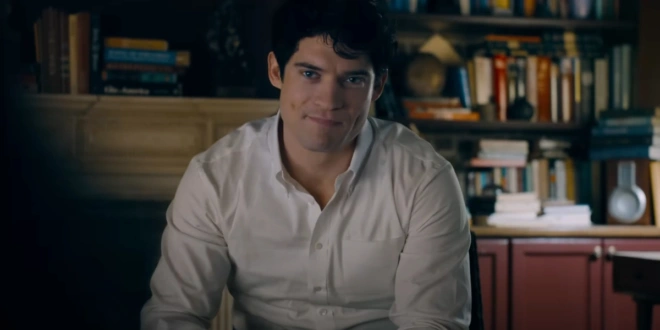 David Corenswet sits in an interview wearing a cocky smirk in Superman.