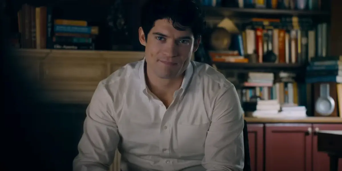David Corenswet sits in an interview wearing a cocky smirk in Superman.