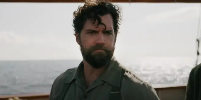 Henry Cavill stands scowling on the deck of a ship in The Ministry of Ungentlemanly Warfare.