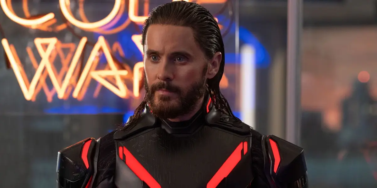 Jared Leto stands patiently in the middle of an office in Tron: Ares.