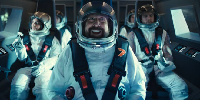 An excited Peter Stormare sits in front of Huda Mustafa and Jake Paul in Call of Duty Black Ops 7's Launch Trailer.