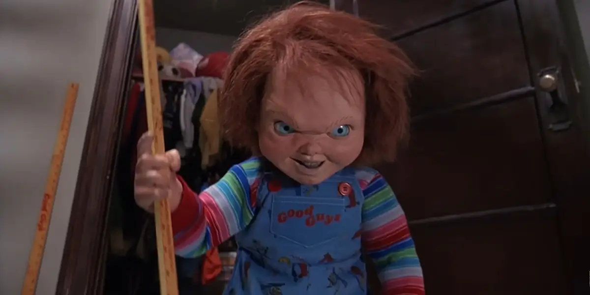 Childs Play 2 Chucky Stands Menacingly While Holding A Yardstick In His Hand