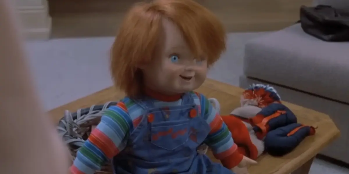 Childs Play Chucky Sits On A Table In His Innocent Doll Form