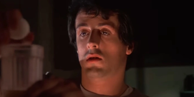 Sylvester Stallone wearily cracks eggs into a glass in the early morning in Rocky.
