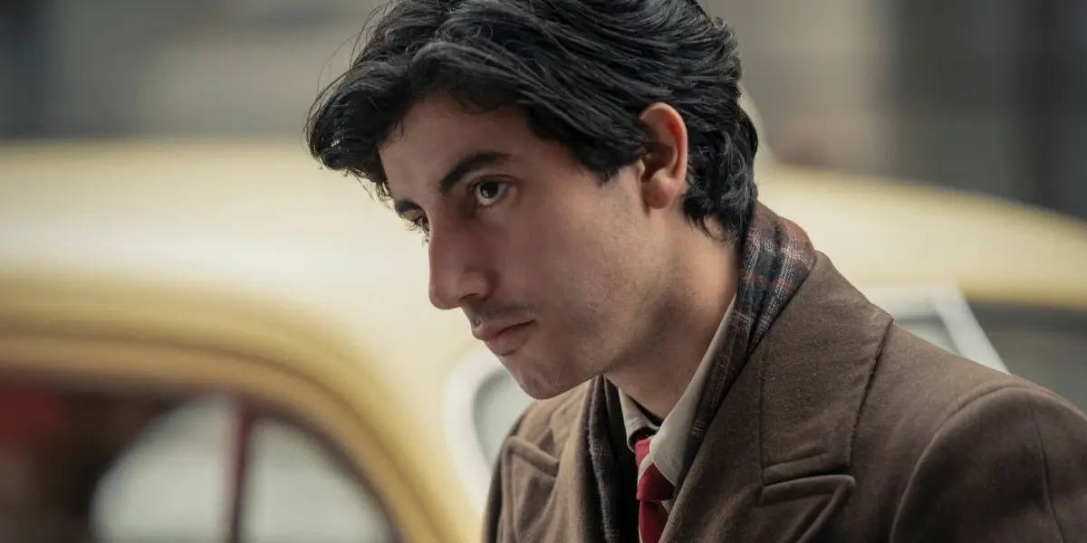 Anthony Ippolito stands with his head cocked on set in The Offer S1 E6 - "A Stand Up Guy."