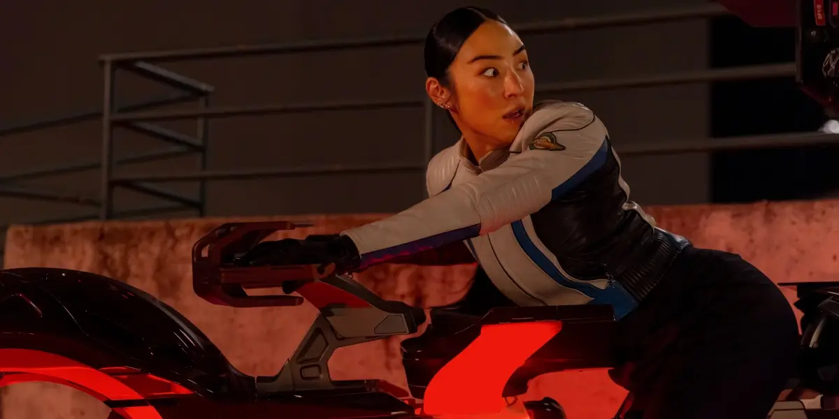Tron Ares Greta Lee Looks Back In Amazement While Driving A Dillinger Light Cycle