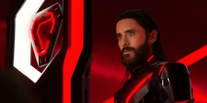 Jared Leto stares intently at his triangle shaped ID disc in Tron: Ares.