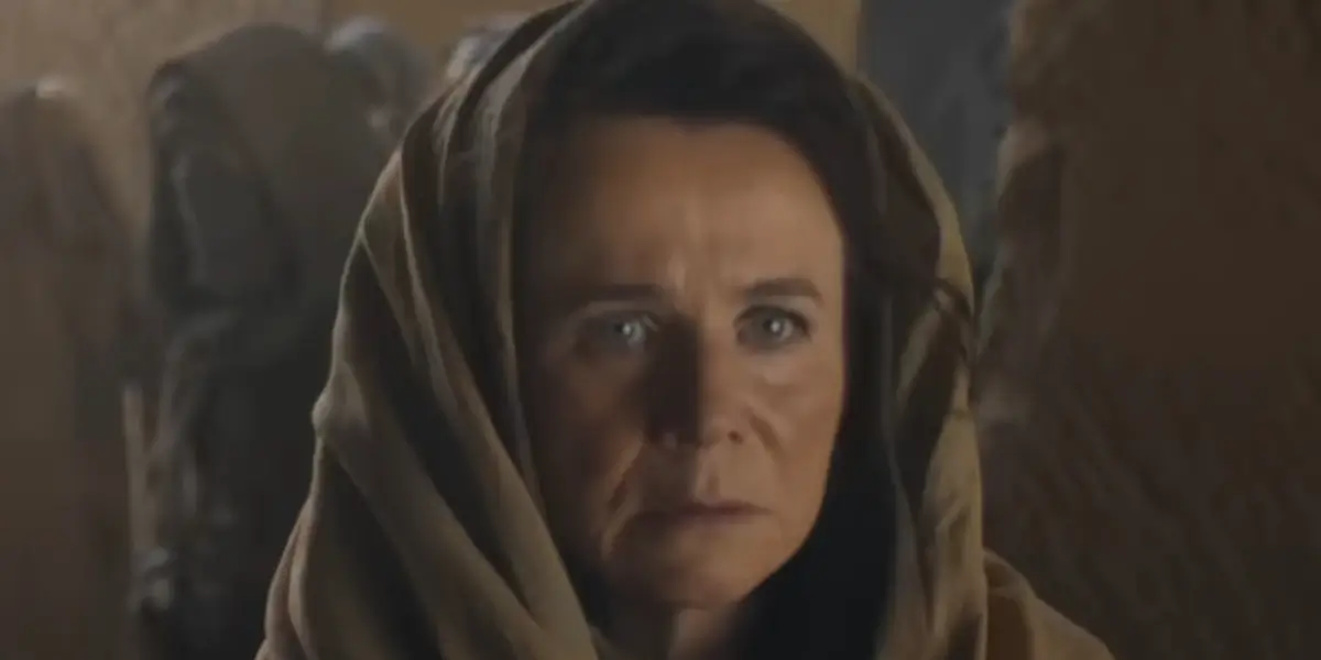 A concerned Emily Watson walks incognito through a crowd in Dune: Prophecy S2.