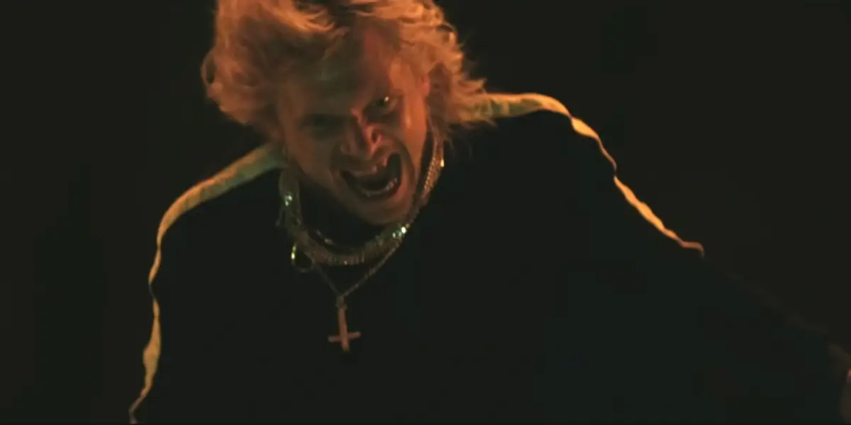 A wind swept Jack O'Connell stands grinning maniacally in 28 Years Later: The Bone Temple.