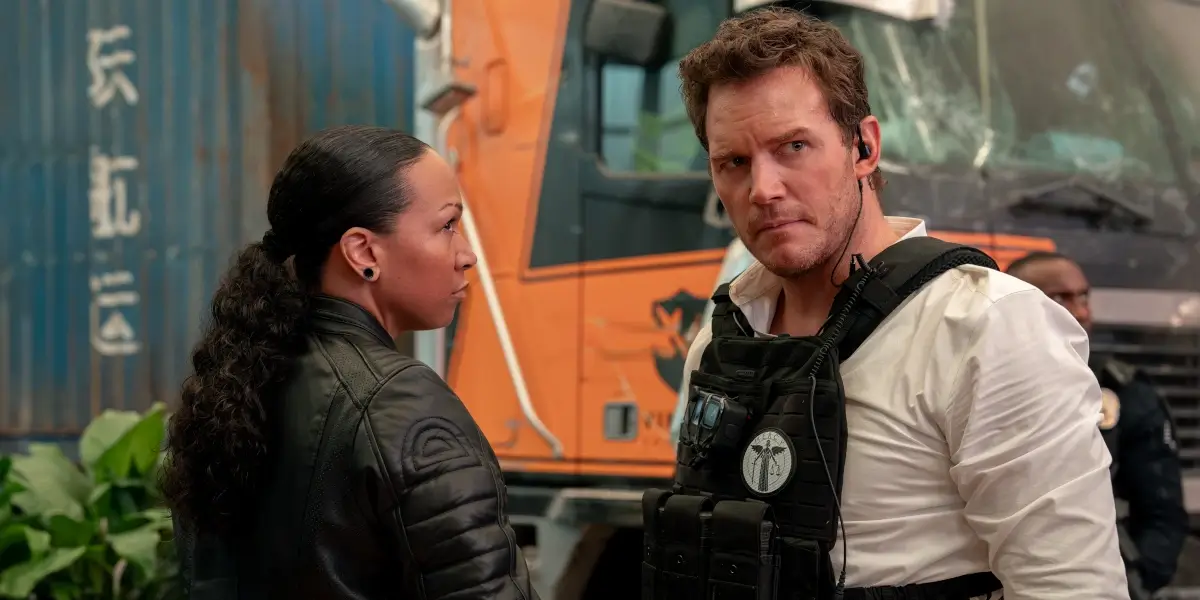 A concerned Kali Reis stars and Chris Pratt talk in the field in Mercy.