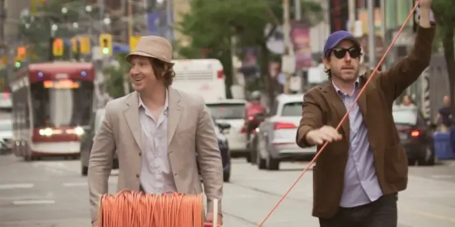 Matt Johnson and Jay McCarrol walk down the street happily in Nirvana the Band the Show the Movie.