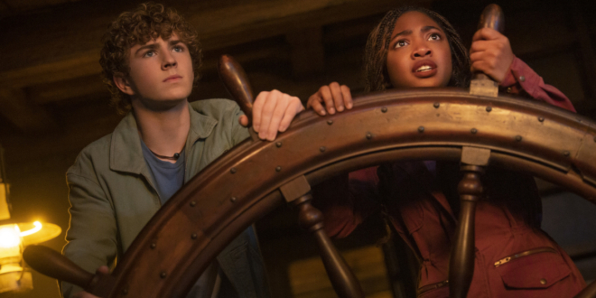 Walker Scobell and Leah Sava Jeffries stand nervously at a ship's wheel in Percy Jackson and the Olympians S2 E4, "Clarisse Blows Up Everything."