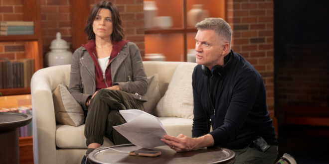 Neve Campbell sits on set as Kevin Williamson gives direction in Scream 7,