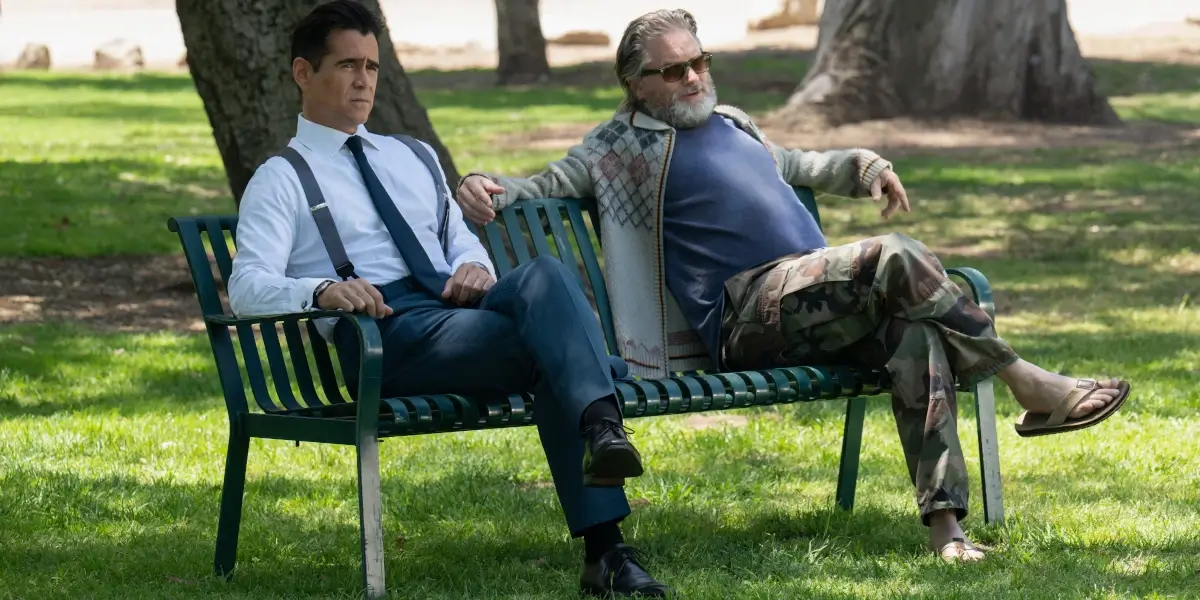 Colin Farrell sits on a bench chatting with a low key Shea Whigham in Sugar Season 2.