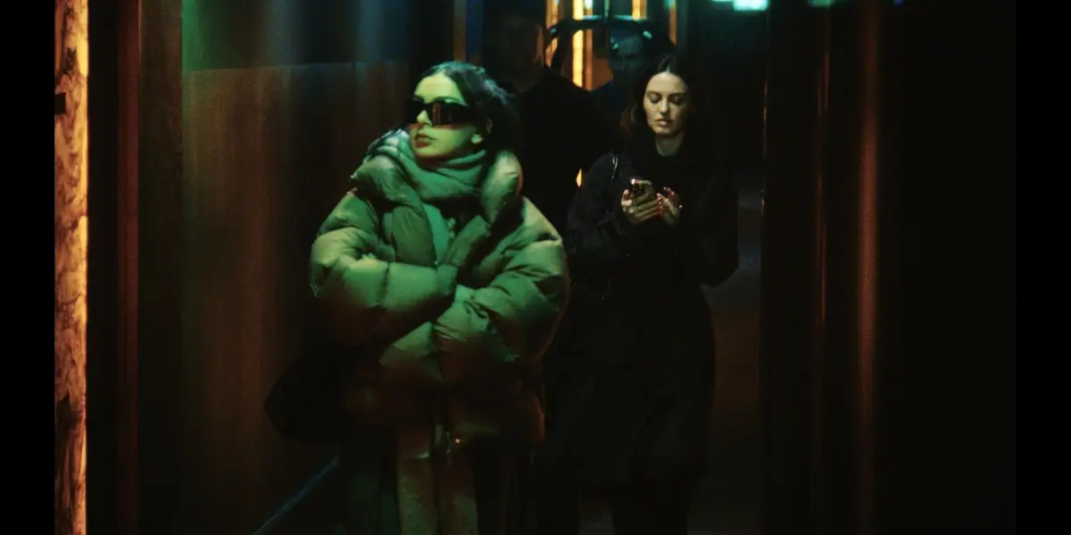 Charli XCX walks incognito through New York at night in The Moment.