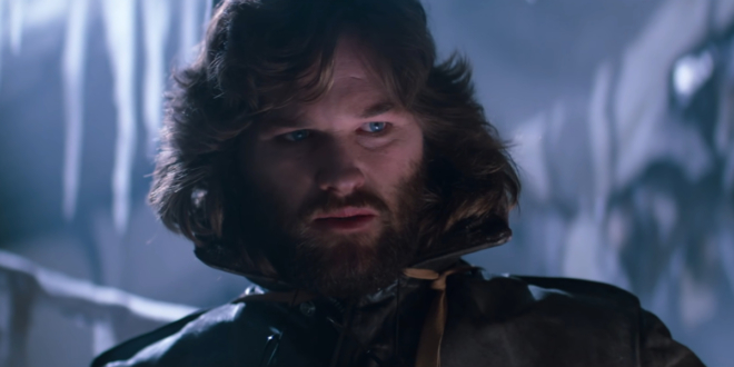 Kurt Russell looks down with concern in a frozen room in The Thing.