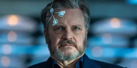 Colin Firth looks ahead with focus wearing sensors on his head in Disclosure Day.
