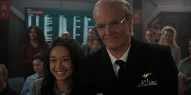 Cynthy Wu and Joel Kinnaman stand together smiling among a crowd in For All Mankind Season 5.