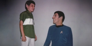 Young Adam Nimoy proudly wears Spock ears in front of a fully costumed Leonard Nimoy, in the For The Love Of Spock trailer.