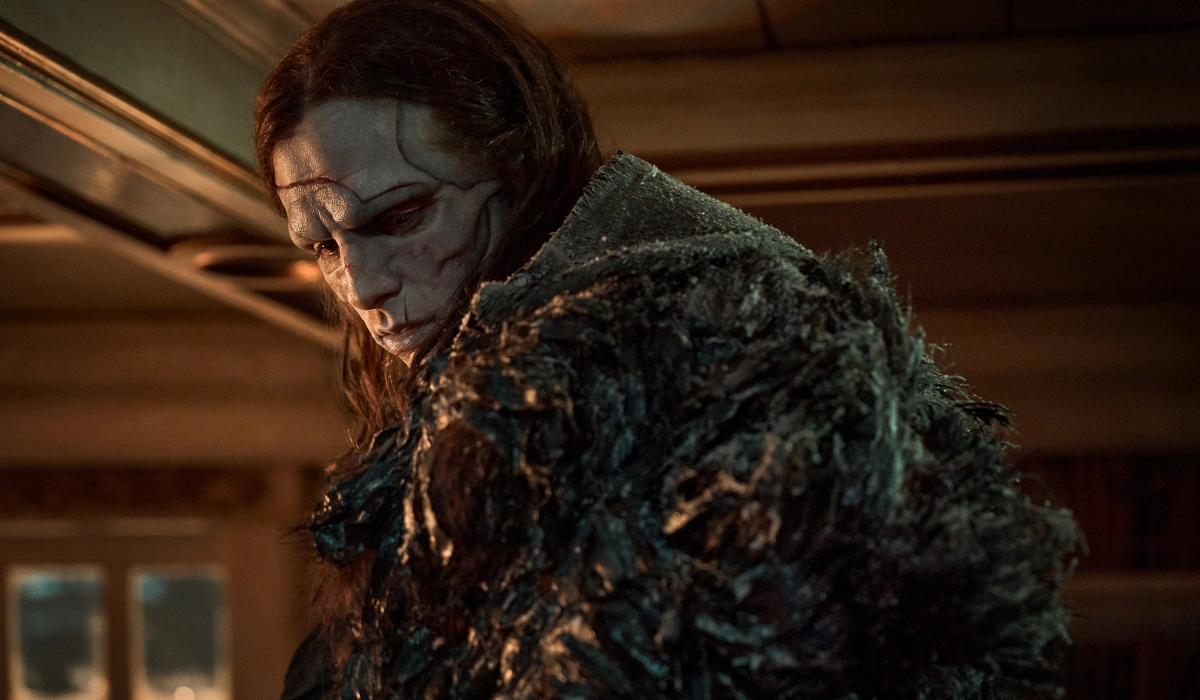 A mournful Jacob Elordi looks over his shoulder in full makeup and costume in Frankenstein.