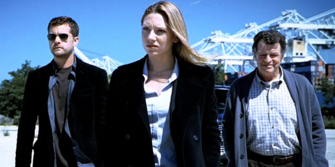 Joshua Jackson, Anna Torv, and John Noble stand together outside in a snowy setting in Fringe.