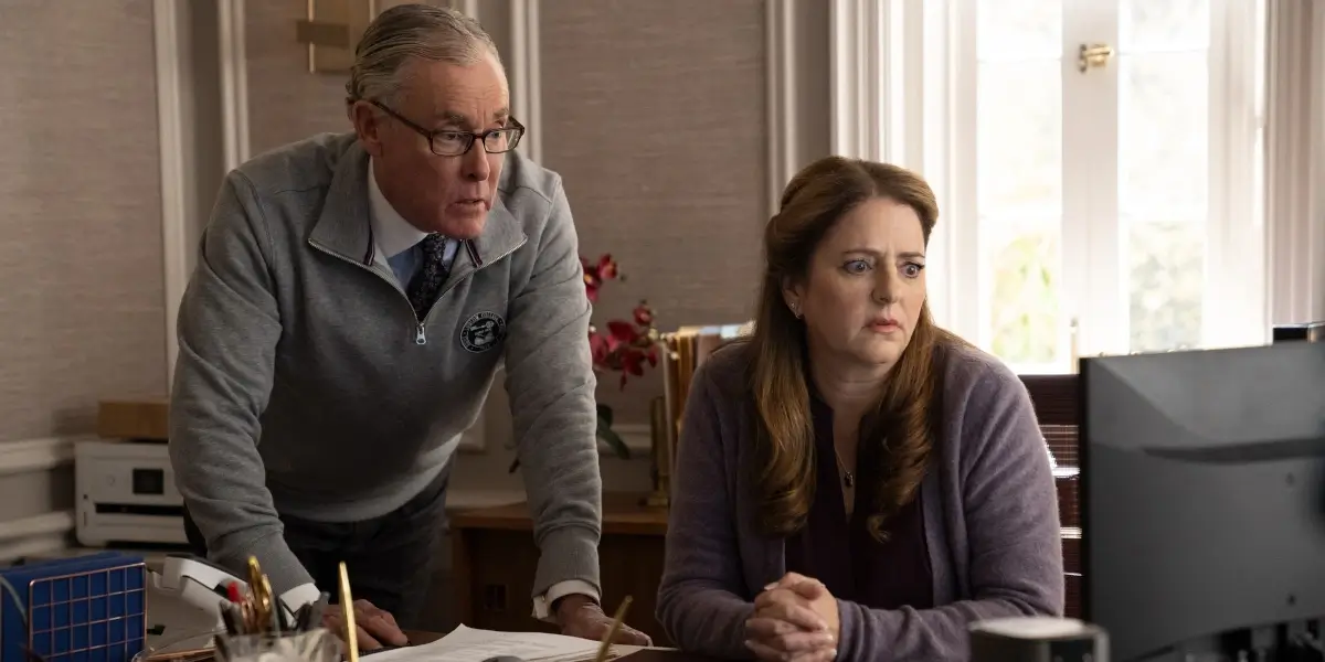 John C McGinley and Annie Mumolo watch a computer monitor with shocked expressions in Rooster.
