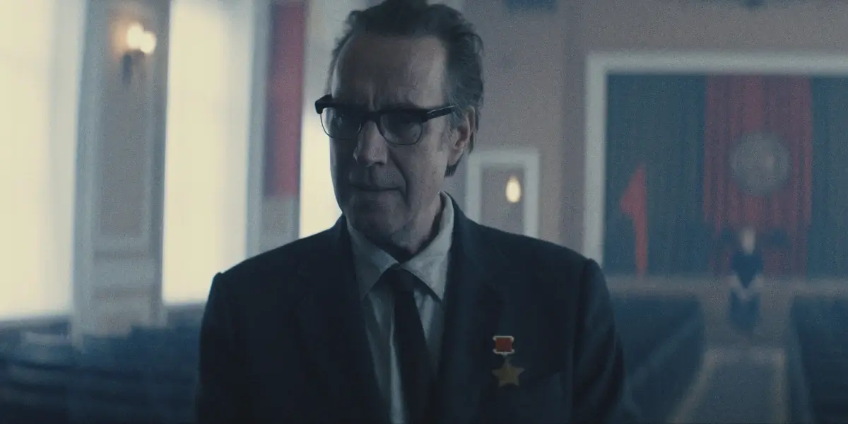 A concerned Rhys Ifans stands in an empty auditorium in Star City, S1 E1.