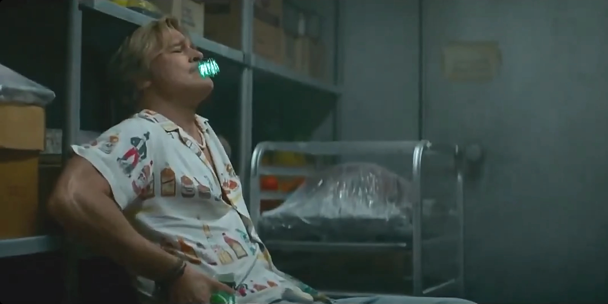 Brad Pitt leans back while smoking a censored joint in The Adventures of Cliff Booth.