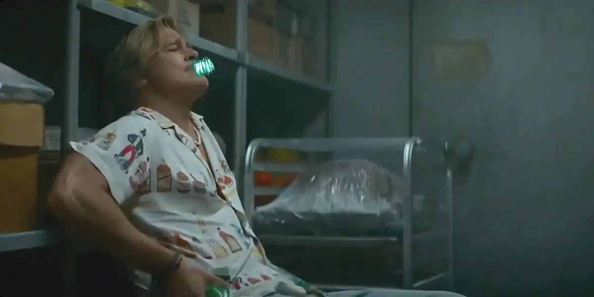 Brad Pitt leans back while smoking a censored joint in The Adventures of Cliff Booth.