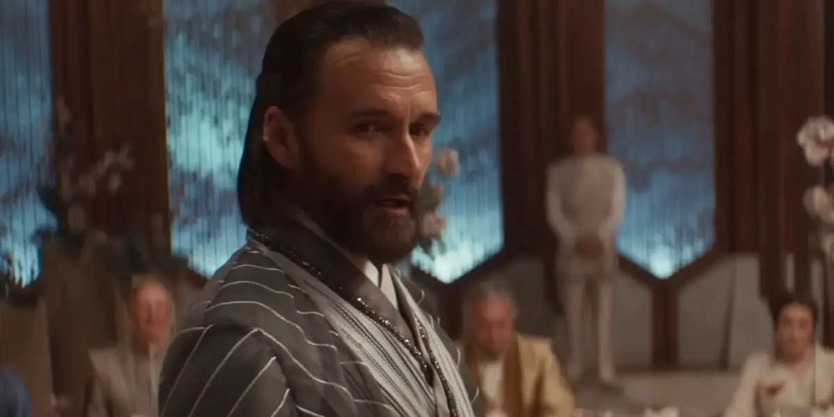 Alastair Mackenzie stands in mid-speech during a wedding reception in Andor S2 E3 - "Harvest."