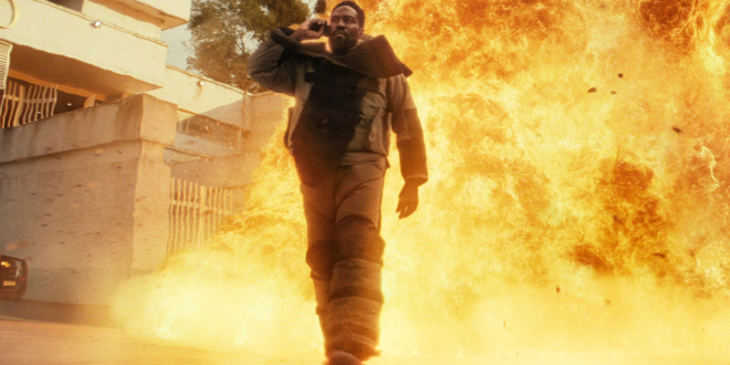 Yahya Abdul-Mateen II walks away from an explosion while taking a phone call in Man on Fire (2026).