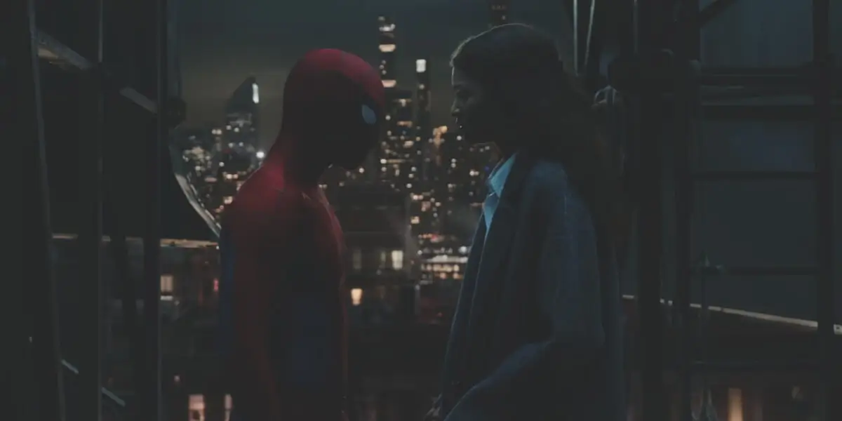 Tom Holland stands in his Spidey costume in front of Zendaya on a dark rooftop in Spider-Man: Brand New Day.