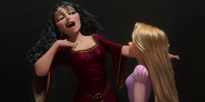 Mother Gothel sings in front of Rapunzel in a darkened room in Tangled.