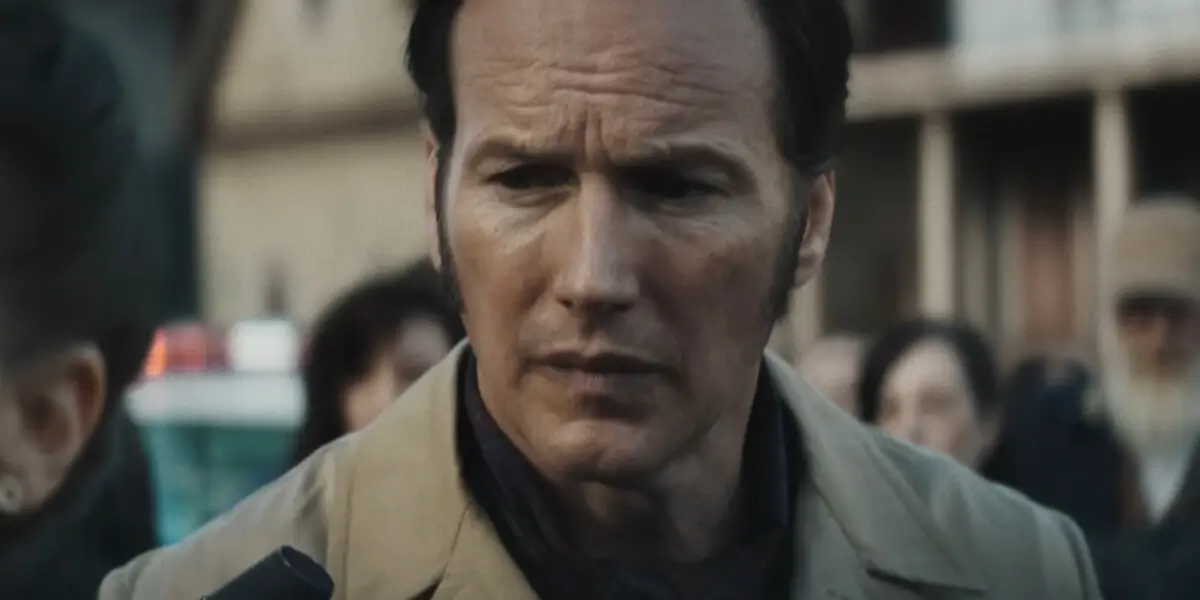 An uneasy Patrick Wilson walks behind Vera Farmiga in The Conjuring: Last Rites.