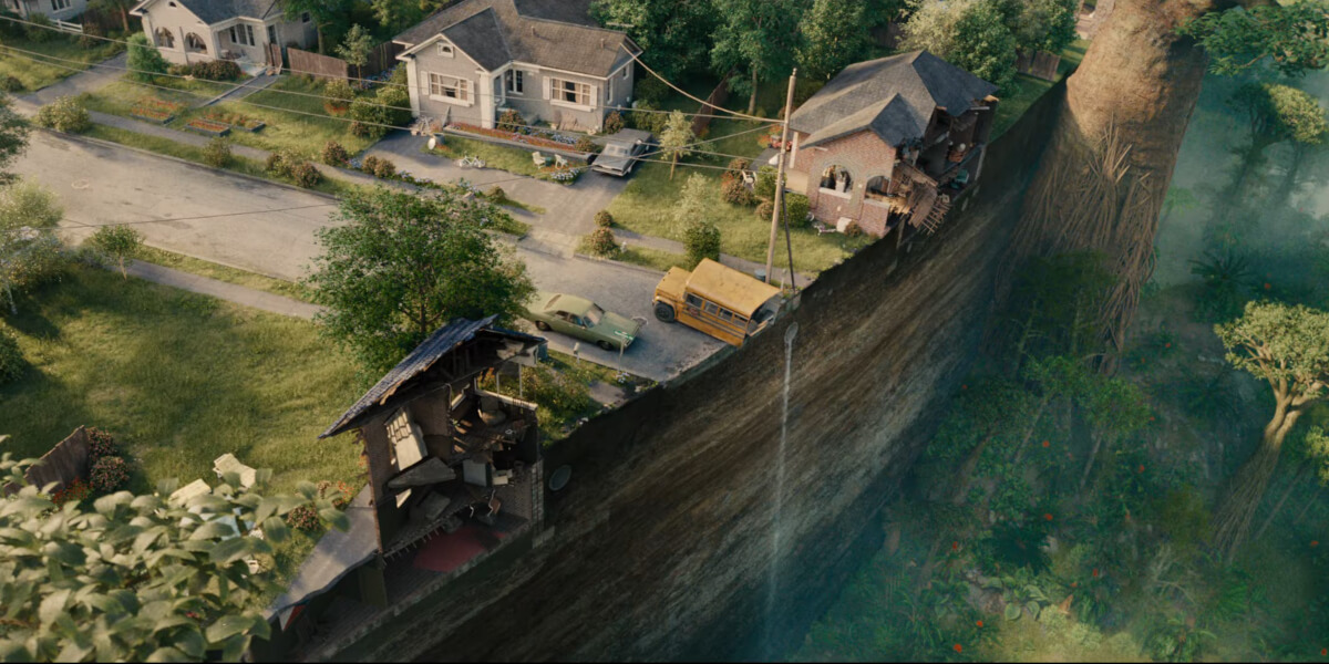 A wide shot of Oak Street dropped in a prehistoric forest in The End of Oak Street.