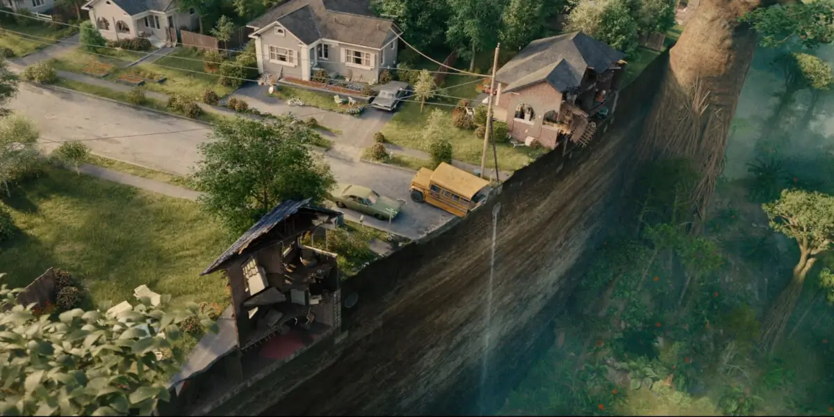 A wide shot of Oak Street dropped in a prehistoric forest in The End of Oak Street.