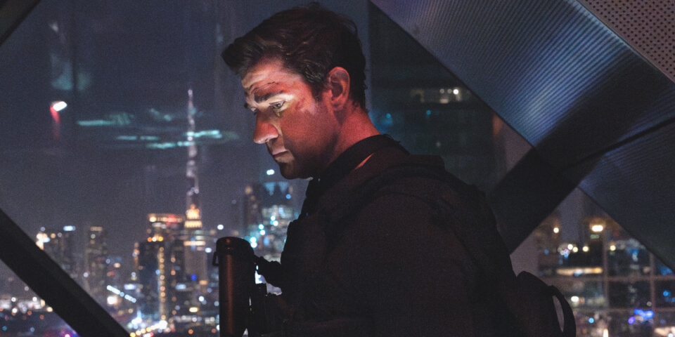 An obscured John Krasinski looks down at a city skyline in Tom Clancy's Jack Ryan: Ghost War.
