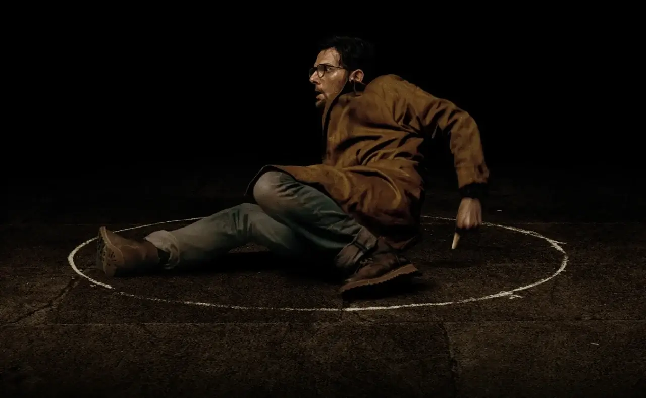 Adam Scott drawing a chalk circle in Hokum. 