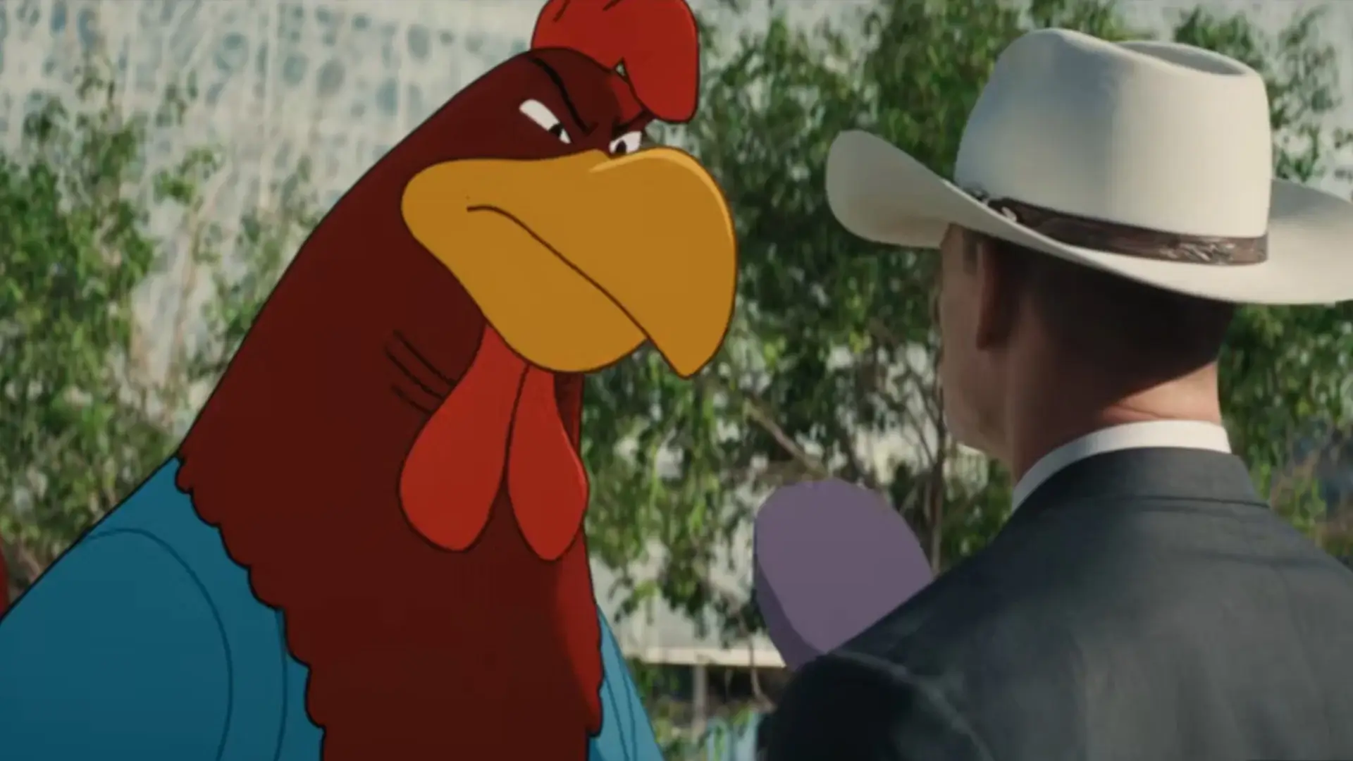 An angry Foghorn Leghorn threatens John Cena with a golf club in conversation in Coyote vs. Acme.