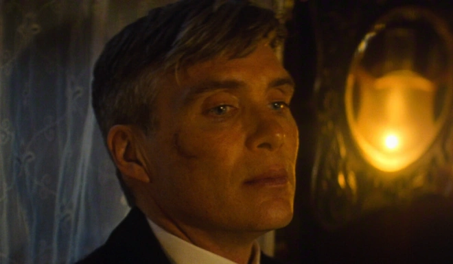 A concerned Cillian Murphy sits in a dimly lit room in Peaky Blinders: The Immortal Man.