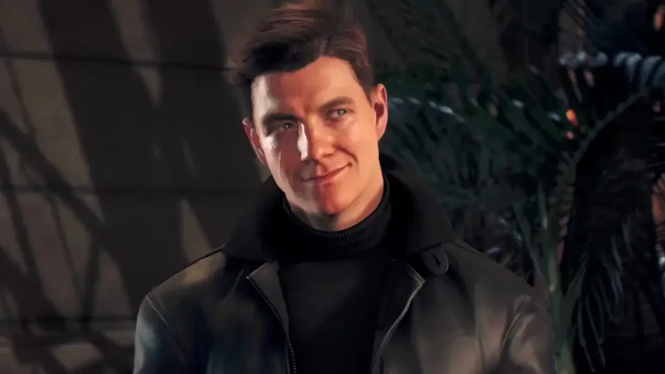 Patrick Gibson stands at a party, dressed in black with a cocky smile, in 007 First Light.