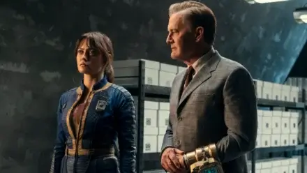A wary Ella Purnell looks ahead as Kyle MacLachlan sternly watches in Fallout Season 2, Episode 7 - "The Handoff."