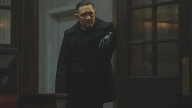 Tom Hardy stands menacingly in a doorway in MobLand S1 E10 - "The Beast In Me."