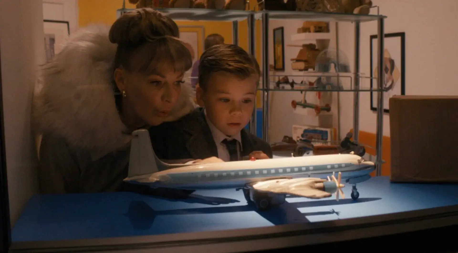 Kid looking at a model plane.