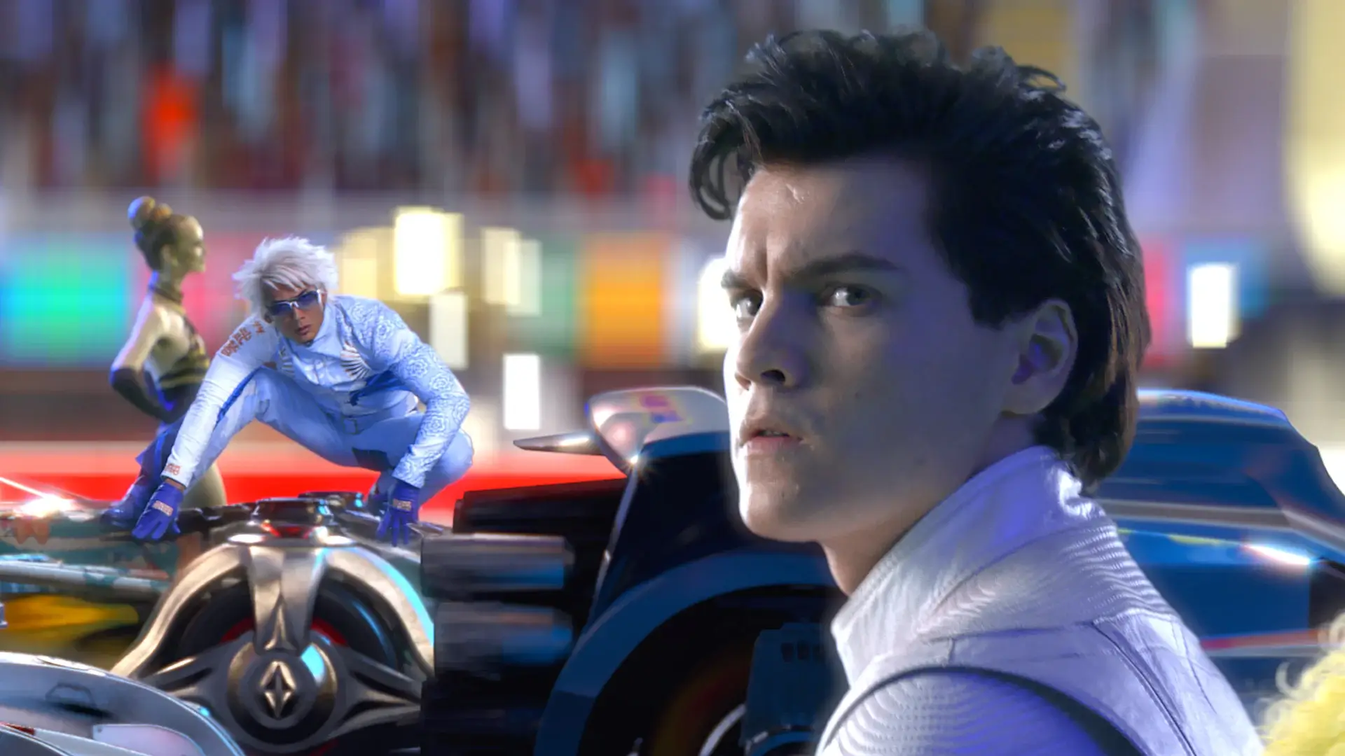 A concerned Emile Hirsch looks upward, while a rival racer watches in Speed Racer.