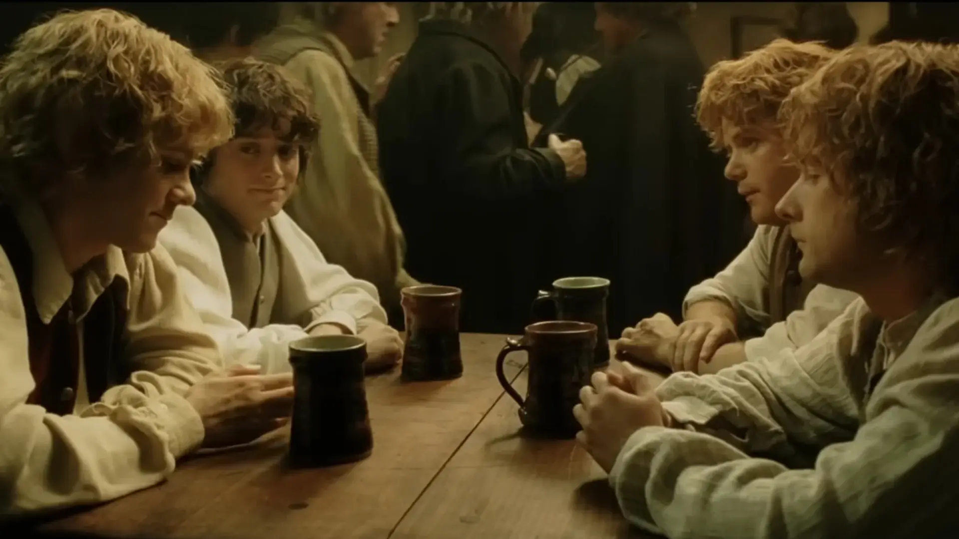 Dominic Monaghan, Elijah Wood, Billy Boyd, and Sean Astin share a drink in the pub in The Lord of the Rings: Return of the King.