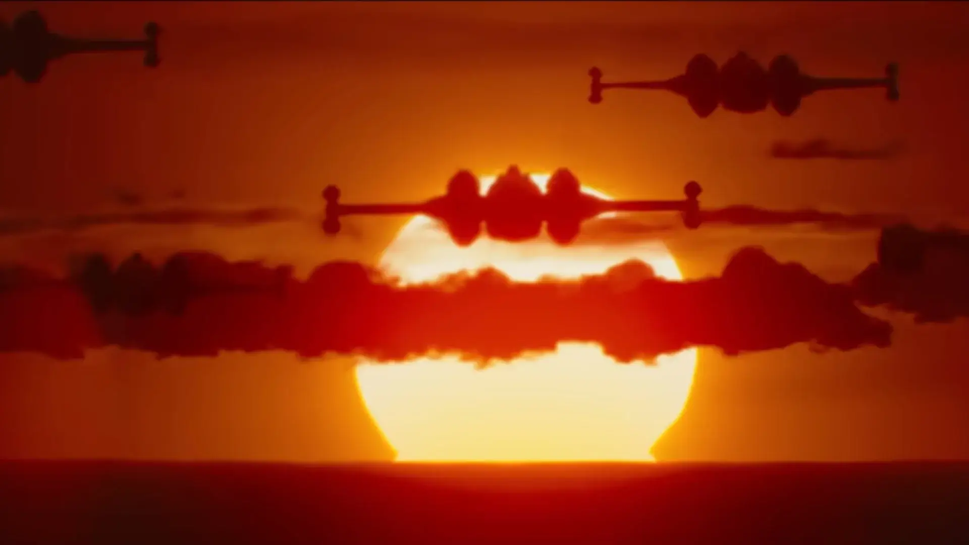 An X-Wing formation flies against an orange sunrise in The Mandalorian and Grogu.